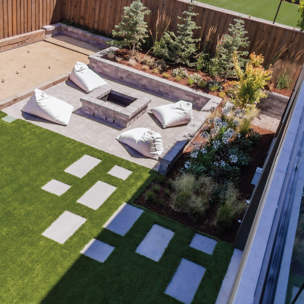 View from deck down to outdoor fire pit and backyard of a custom home View from deck down to outdoor fire pit and backyard of a custom home built by Riddle Construction