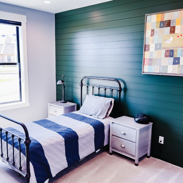 A farmhouse inspired bedroom with a twin bed cover in a striped duvet A farmhouse inspired bedroom with a twin bed cover in a striped duvet