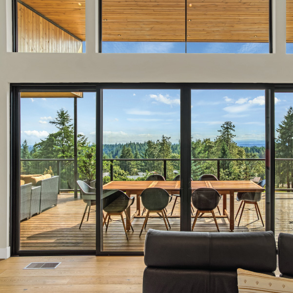 View through the large sliding doors of a modern home built by Riddle Construction View through the large sliding doors of a custom home built by Riddle Construction