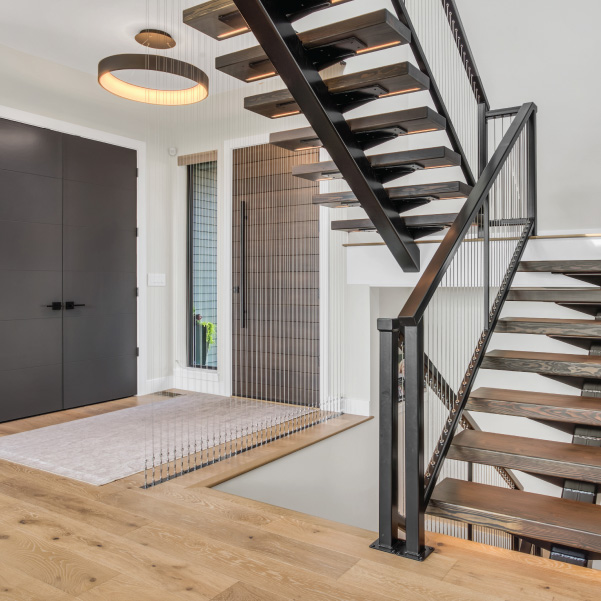 Front entry with a steel staircase in a custom home built by Riddle Construction Front entry with a steel staircase in a custom home built by Riddle Construction