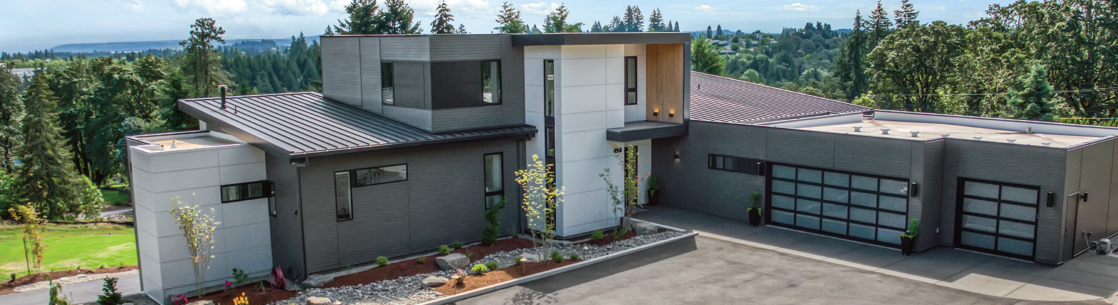 Aerial view of the courtyard entry to a custom home built by Riddle Construction Industrial Modern Retreat