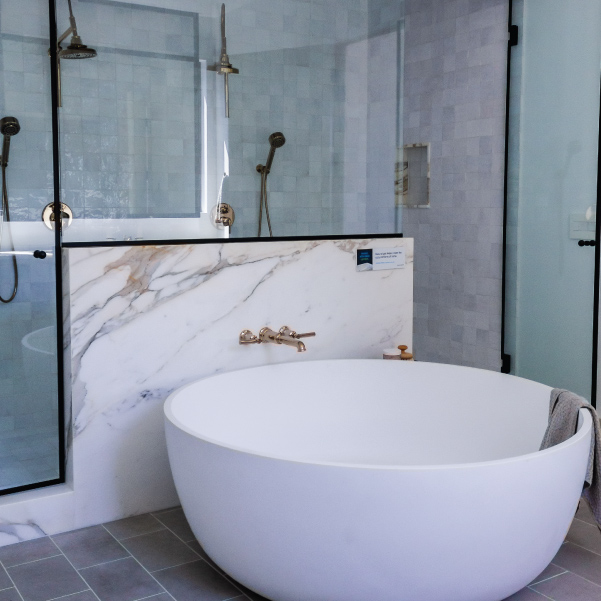 White round soaking tub and walk-in shower for a bathroom in an organic modern style built by Riddle Construction White round soaking tub and walk-in shower for a bathroom in an organic modern style built by Riddle Construction