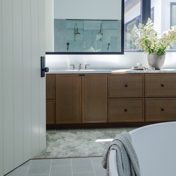 Full-size hanging bathroom mirror over a single sink in a Street of Dreams home built by Riddle Construction Full-size hanging bathroom mirror over a single sink in a Street of Dreams home built by Riddle Construction