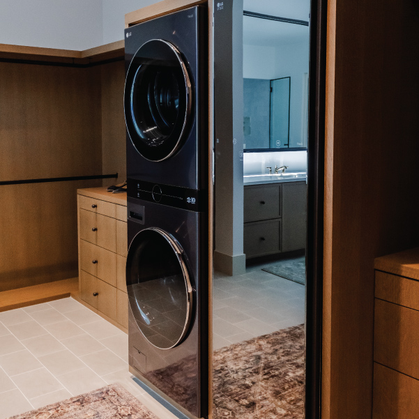 Modern washer and dryer in a walk-in closet of Lagom built by Riddle Construction Modern washer and dryer in a walk-in closet of Lagom built by Riddle Construction