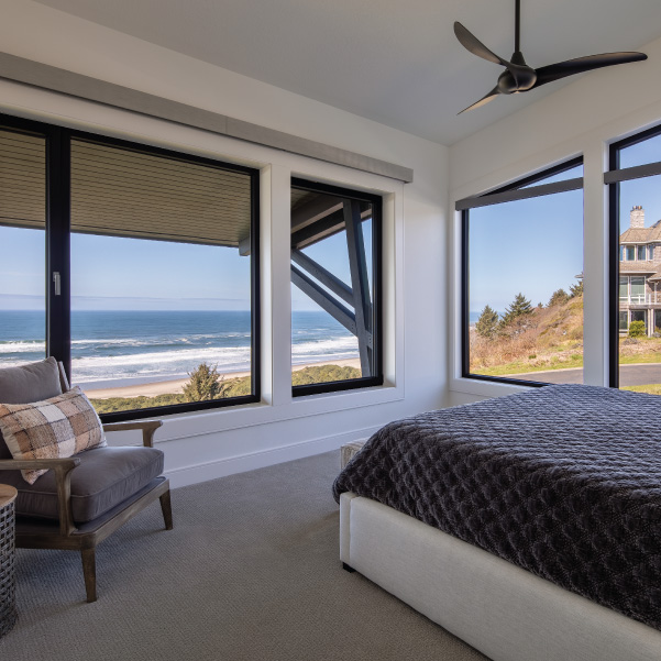 Corner windows of a bedroom in a modern coastal home built by Riddle Construction Modern Coastal Sanctuary