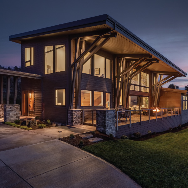 Nighttime view of a interiorly lit modern coastal home built by Riddle Construction in Neskowin, Oregon Nighttime view of a interiorly lit modern coastal home built by Riddle Construction in Neskowin, Oreogn