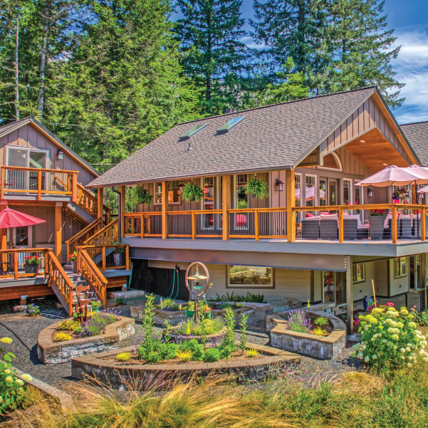 This riverfront lodge features multiple decks to capture river views Rustic Modern Lodge