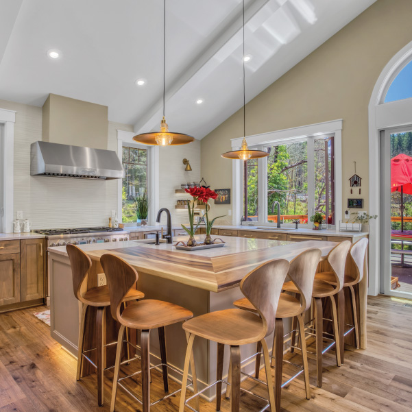 A kitchen island with stools in a rustic modern home built by Riddle Construction A kitchen island with stools in a rustic modern home built by Riddle Construction