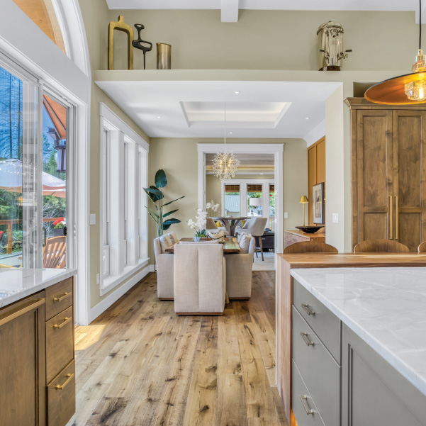 An interior look through the kitchen and dining room of a modern home built by Riddle Construction An interior look through the kitchen and dining room of a modern home built by Riddle Construction