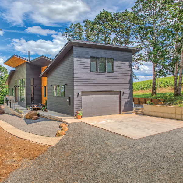 Driveway view of home in Oregon’s wine country built by Riddle Construction Wine Country Home in Art Deco
