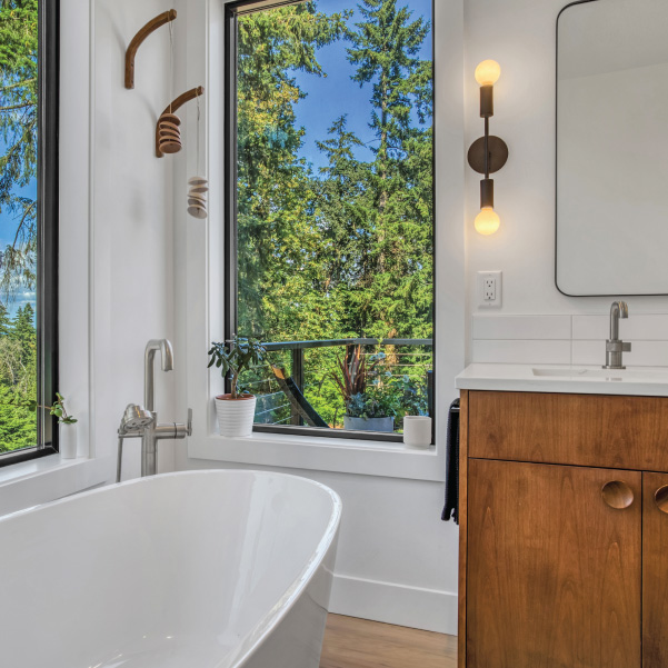 Bathtub and vanity sink next to bathroom window Bathtub and vanity sink next to bathroom window