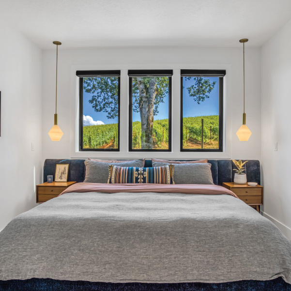 Master bedroom with three vertical windows for a vineyard view for a wine country home built by Riddle Construction Master bedroom with three vertical windows for a vineyard view for a wine country home built by Riddle Construction
