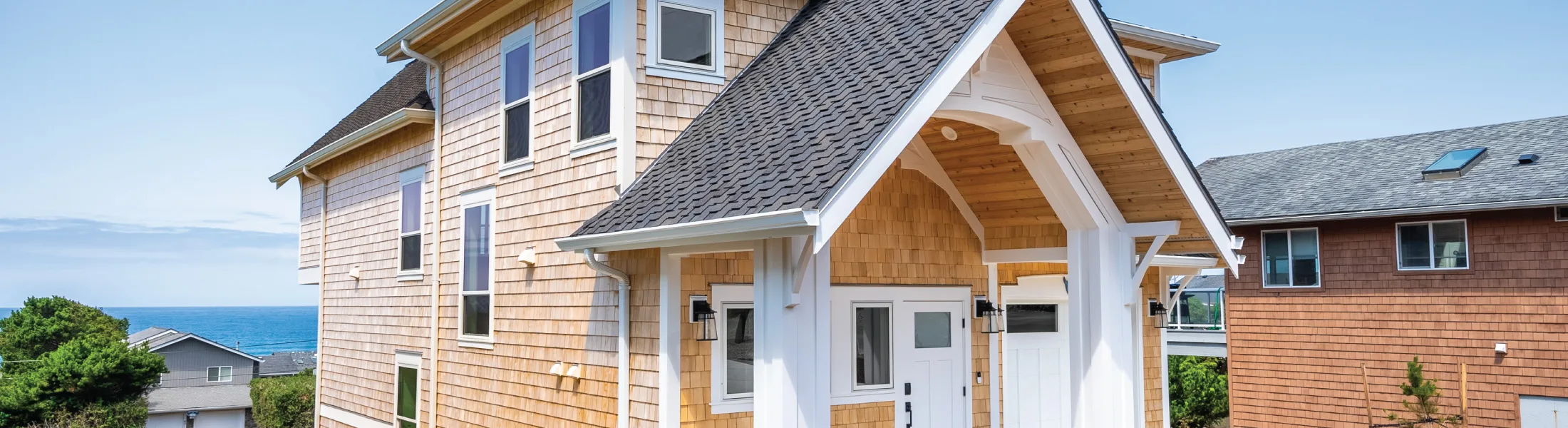 The entry of a multi-level Oregon Coast cottage designed by Capri Architecture Coastal Capri Cottage