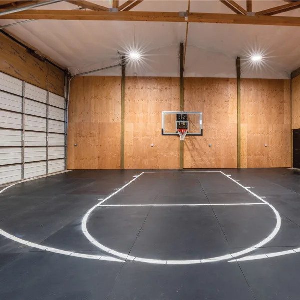 Sport court in a pole barn built with a custom ranch home by Riddle Construction Sport court in a pole barn built with a custom ranch home by Riddle Construction