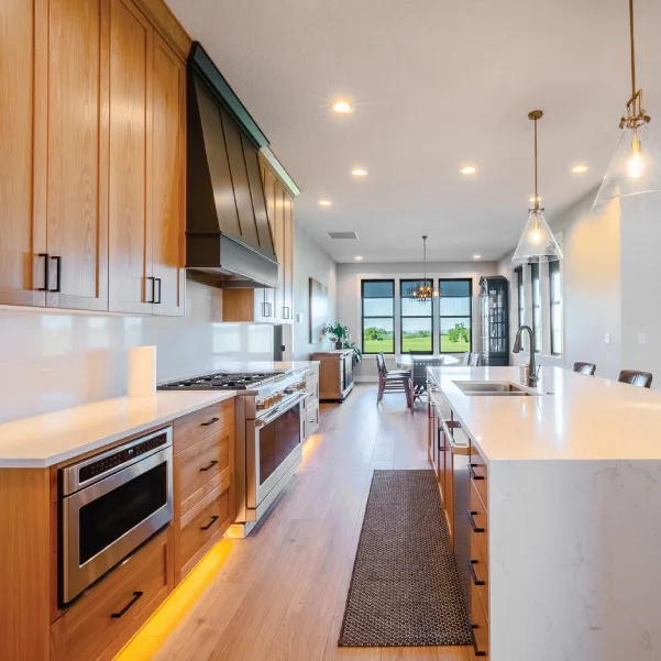 View through kitchen with large island leading to three windows View through kitchen with large island leading to three windows